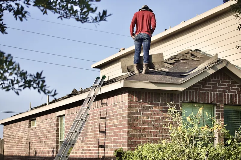 Professional roofer working on a residential roof in Brandon